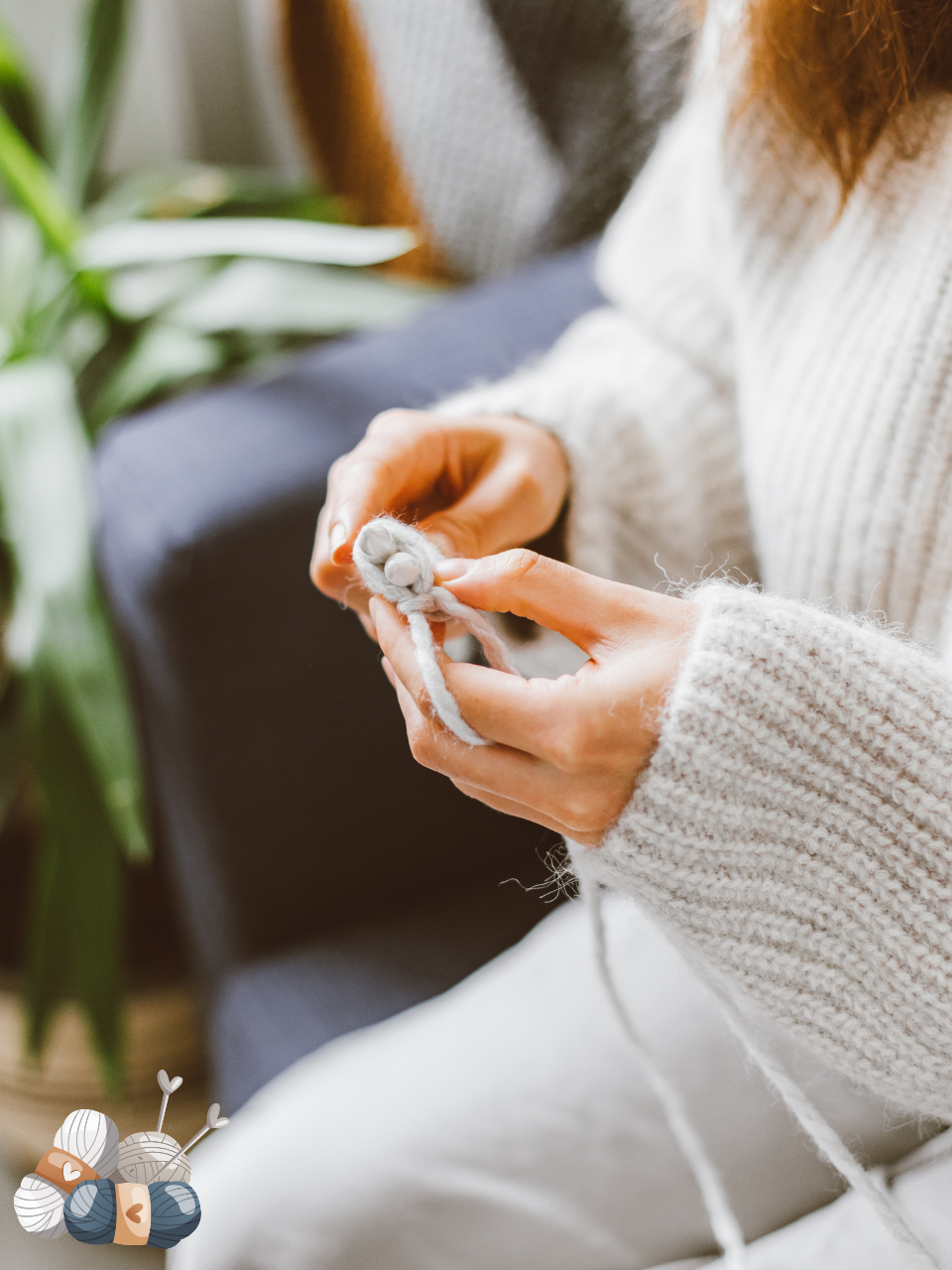 close up of hands knitting with white yarn